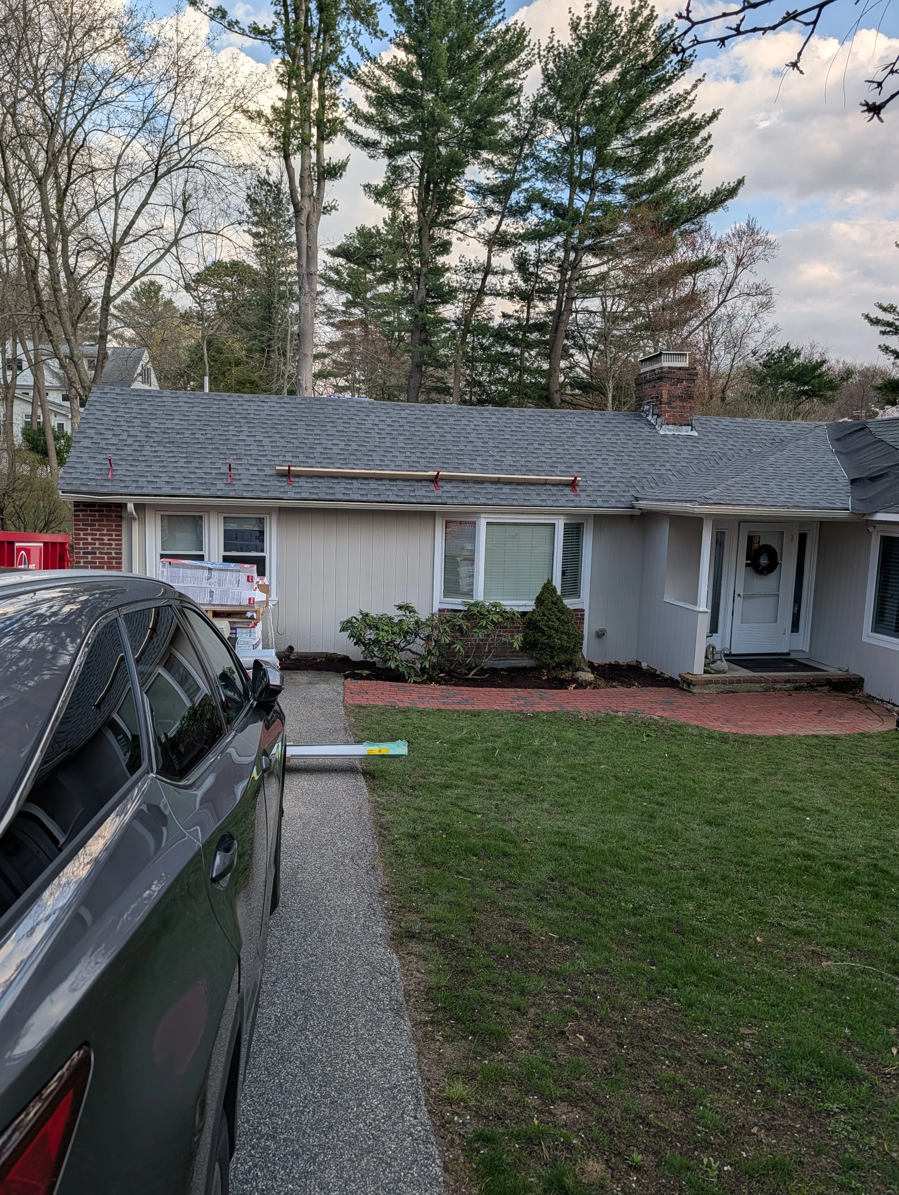 New slate gray shingle roof on brick and siding ranch home in Greenville